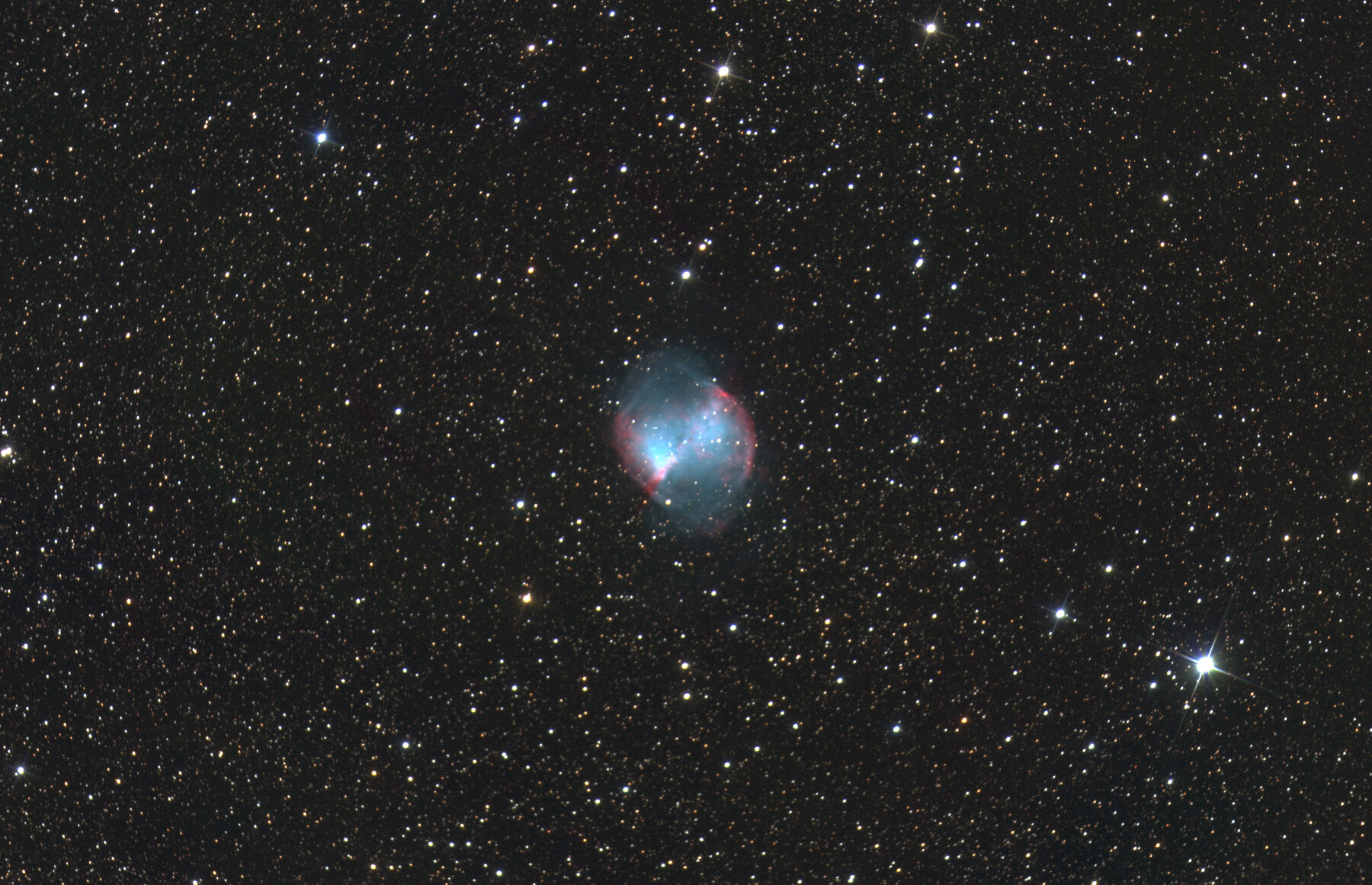 The Dumbbell Nebula surrounded by a dense field of stars