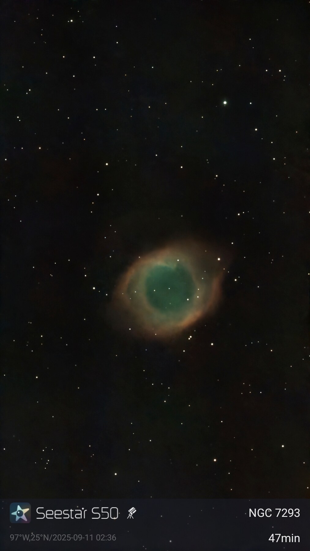 The Helix Nebula glowing red and blue in a field of stars