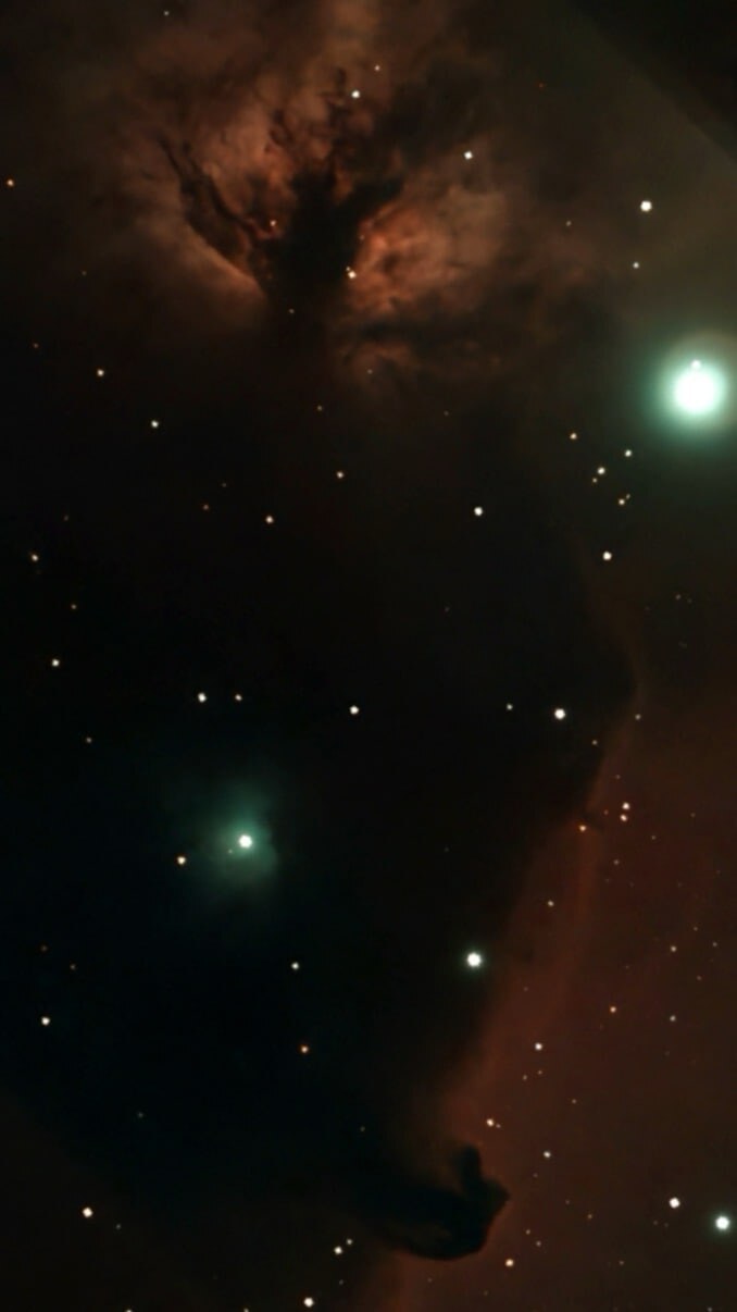 The dark Horsehead Nebula against glowing hydrogen gas
