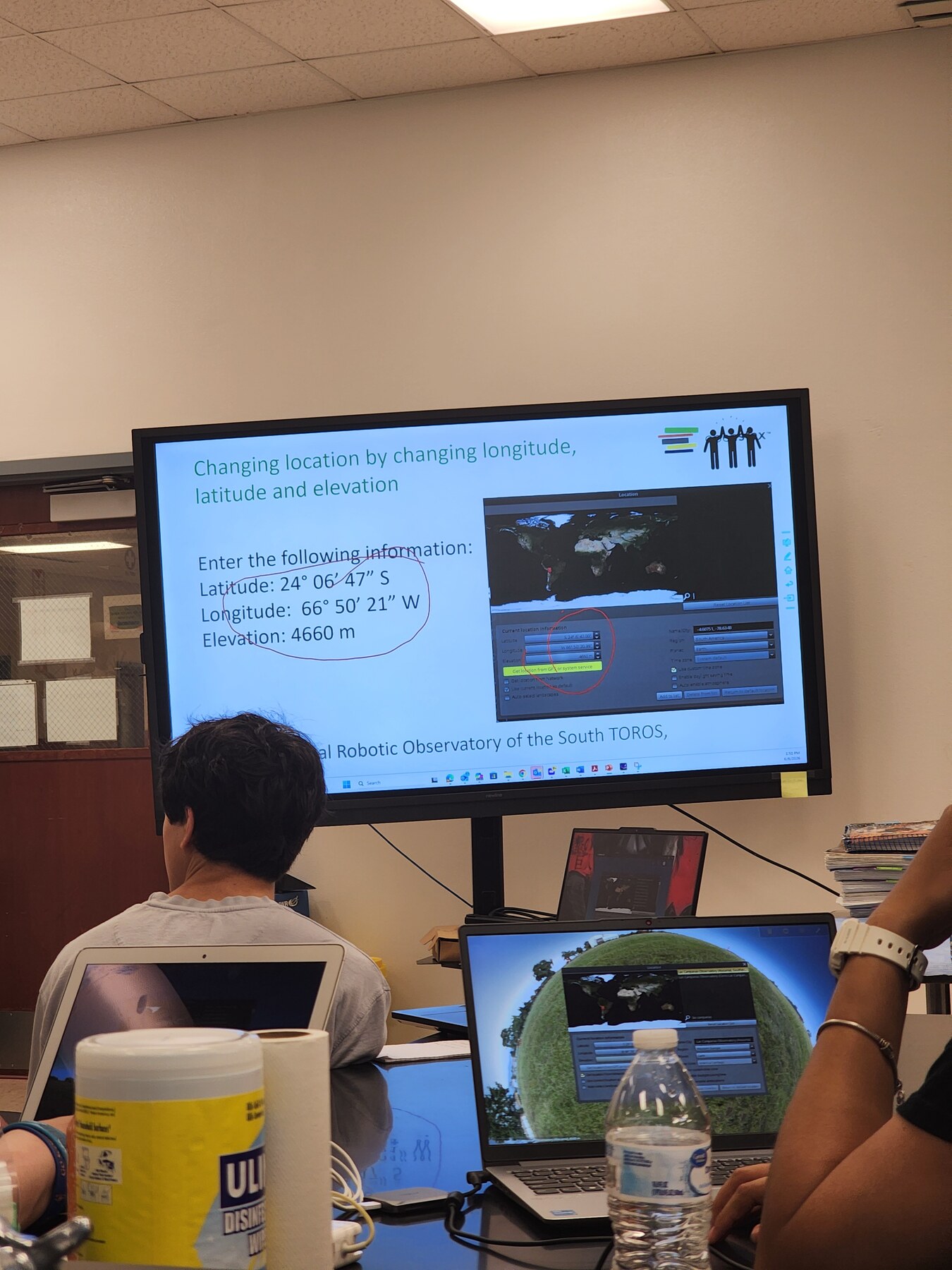Astronomy workshop participants learning together in front of a projection screen