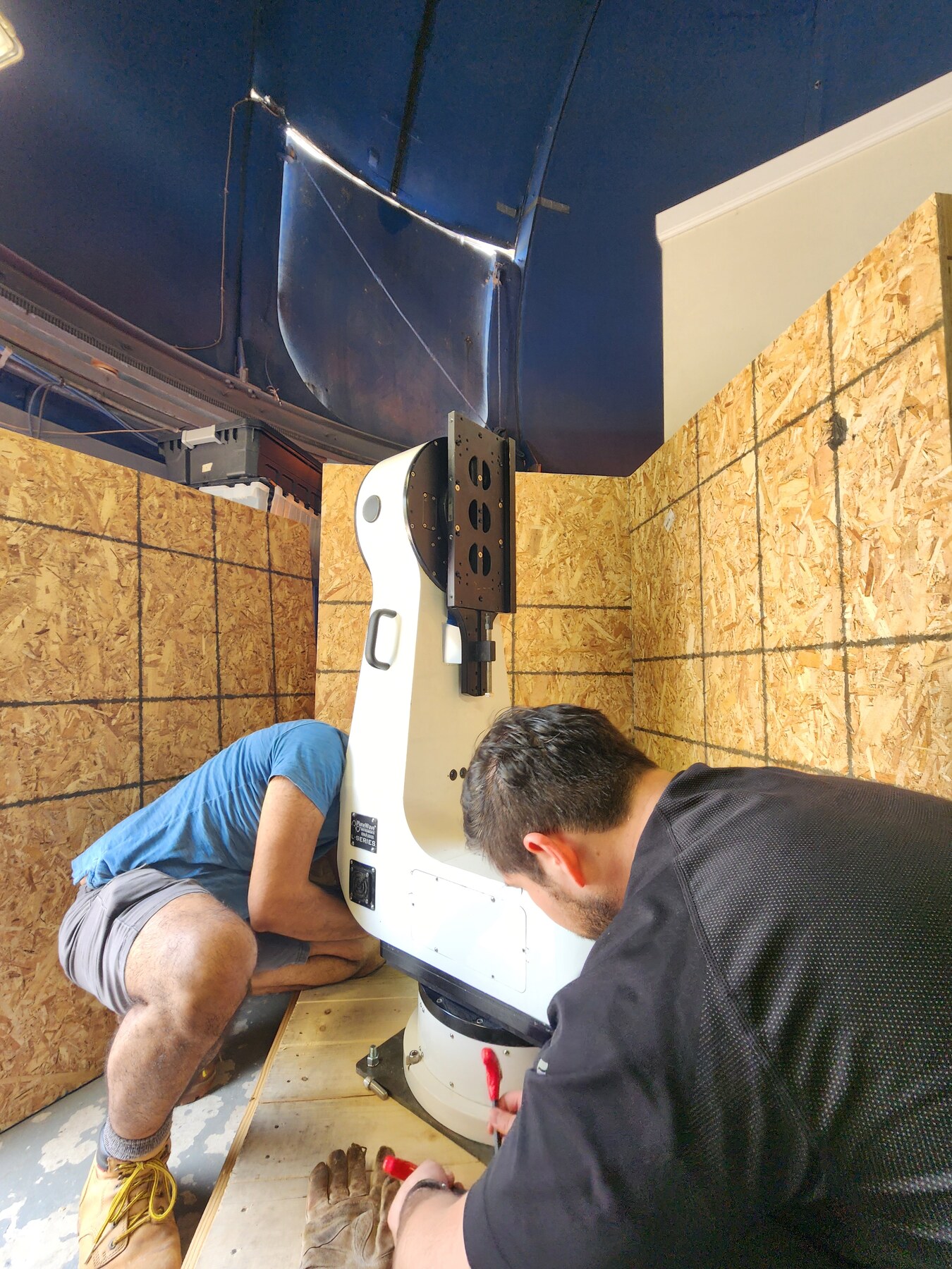The observatory team preparing a telescope mount for repair