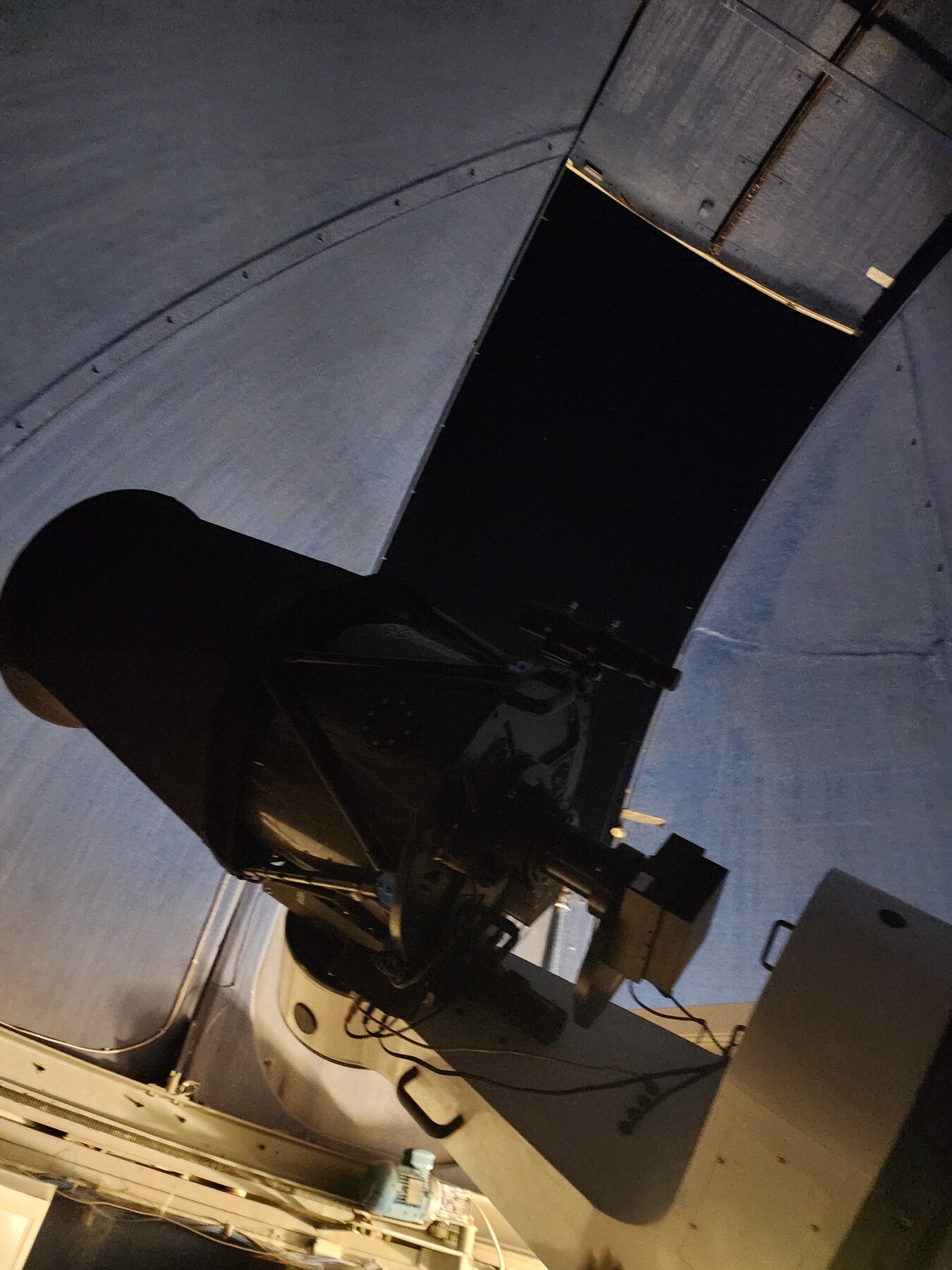 The observatory PlaneWave telescope inside its dome at night